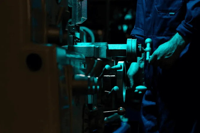 A man working on a machine in a factory.