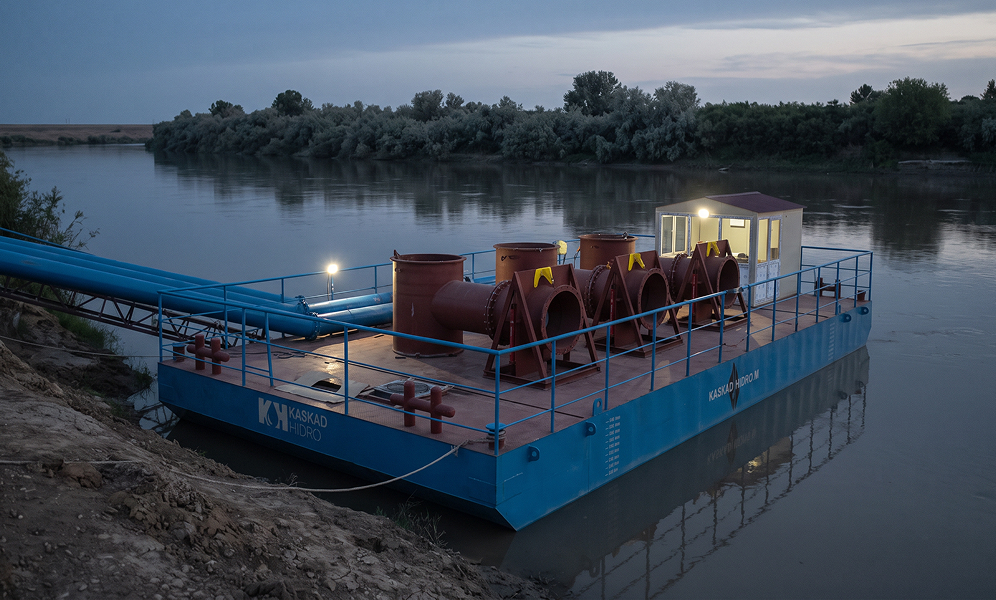 Floating pump station on the river at dusk, Sabirabad District