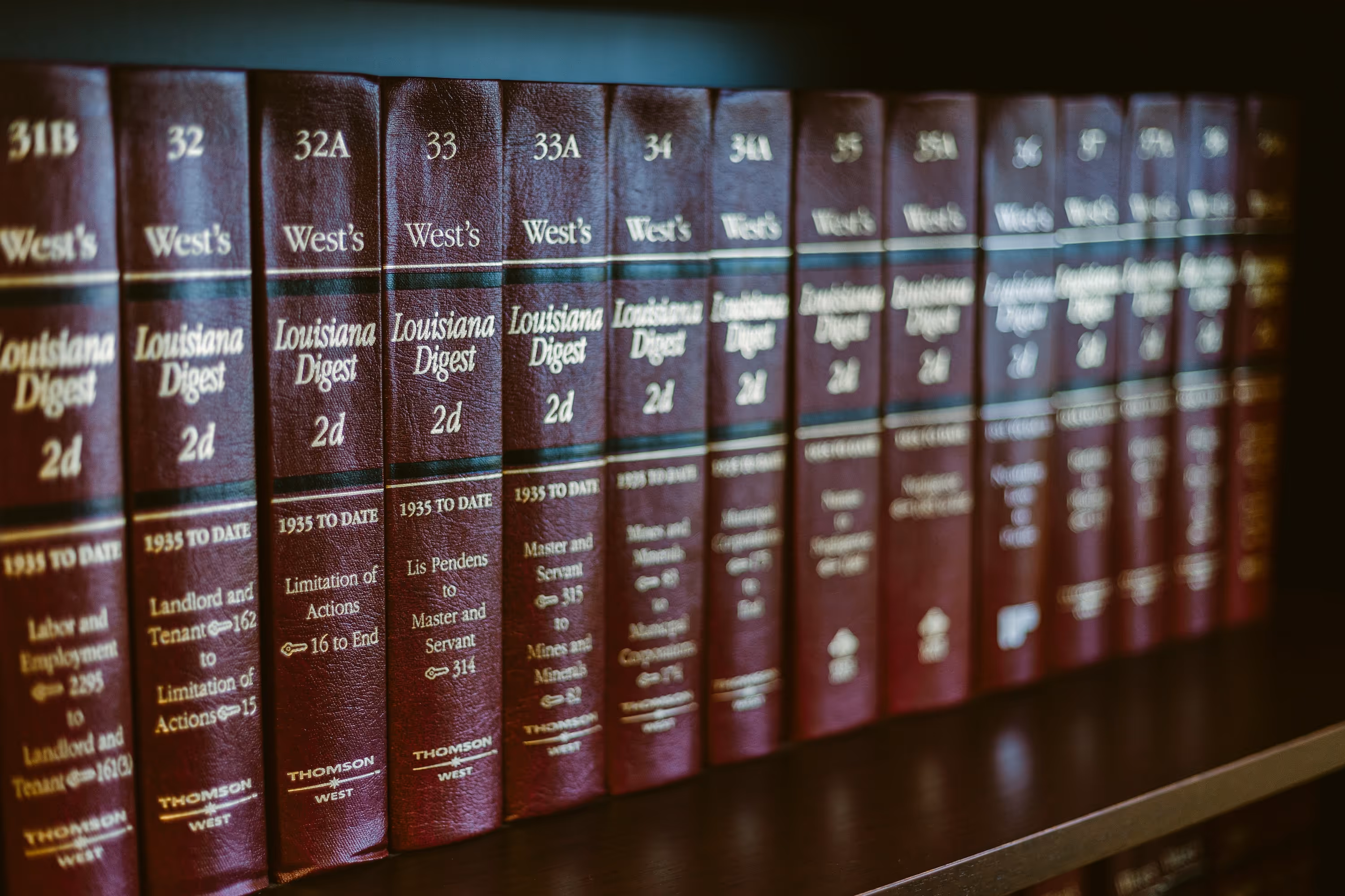 Shelf of maroon West's Louisiana Digest legal books arranged in sequence.
