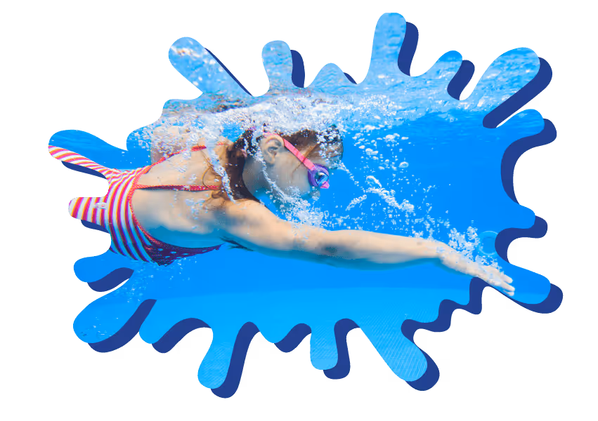 Child swimming underwater in pool wearing goggles and a red and white striped swimsuit.