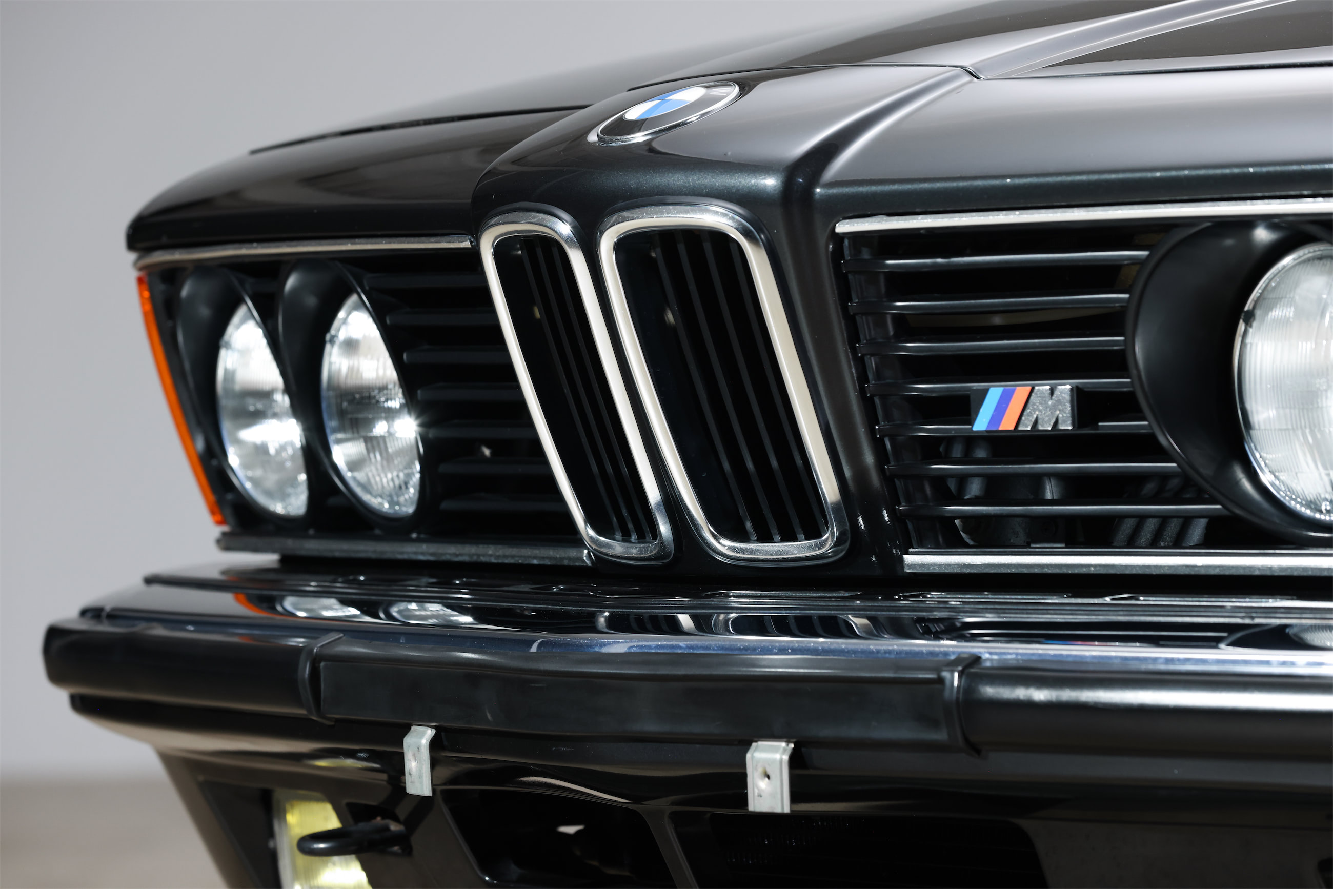 Close-up shot of a pristine grill on a vintage black BMW