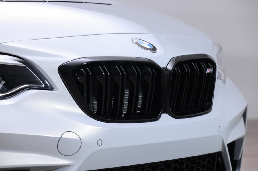 Close-up shot of the grill of a white BMW