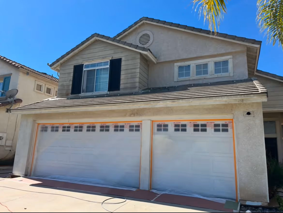 A white and gray house before being painted.