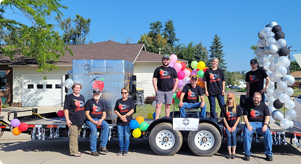 a group of team members sitting on a parade float