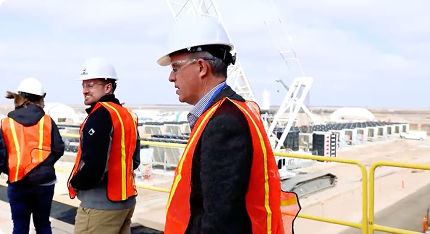 a group of applied digital workers wearing safety vests and hard hats