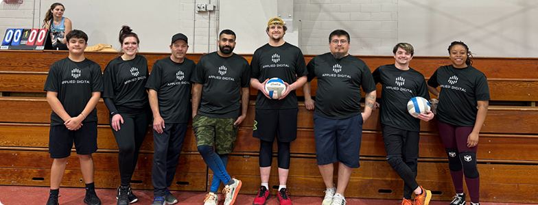 a group of volleyball players sponsored by Applied Digital