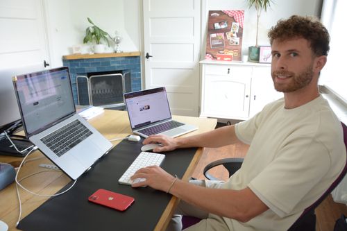 a photo of the founder behind is laptop