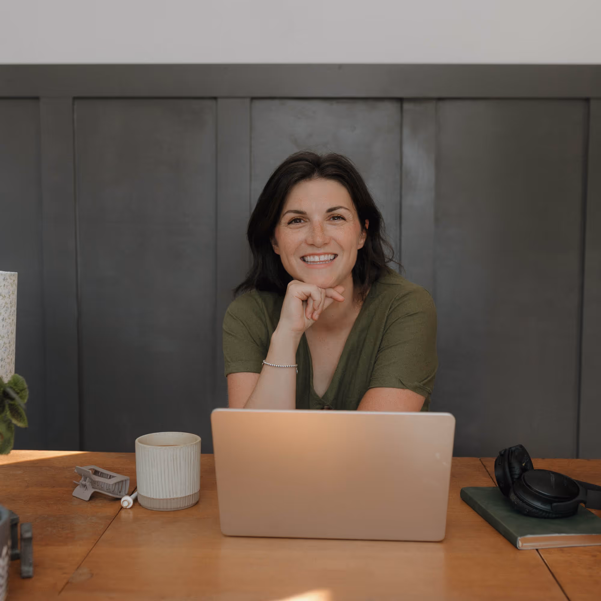 Devyn sat behind the desk with her laptop, smiling at the camera.