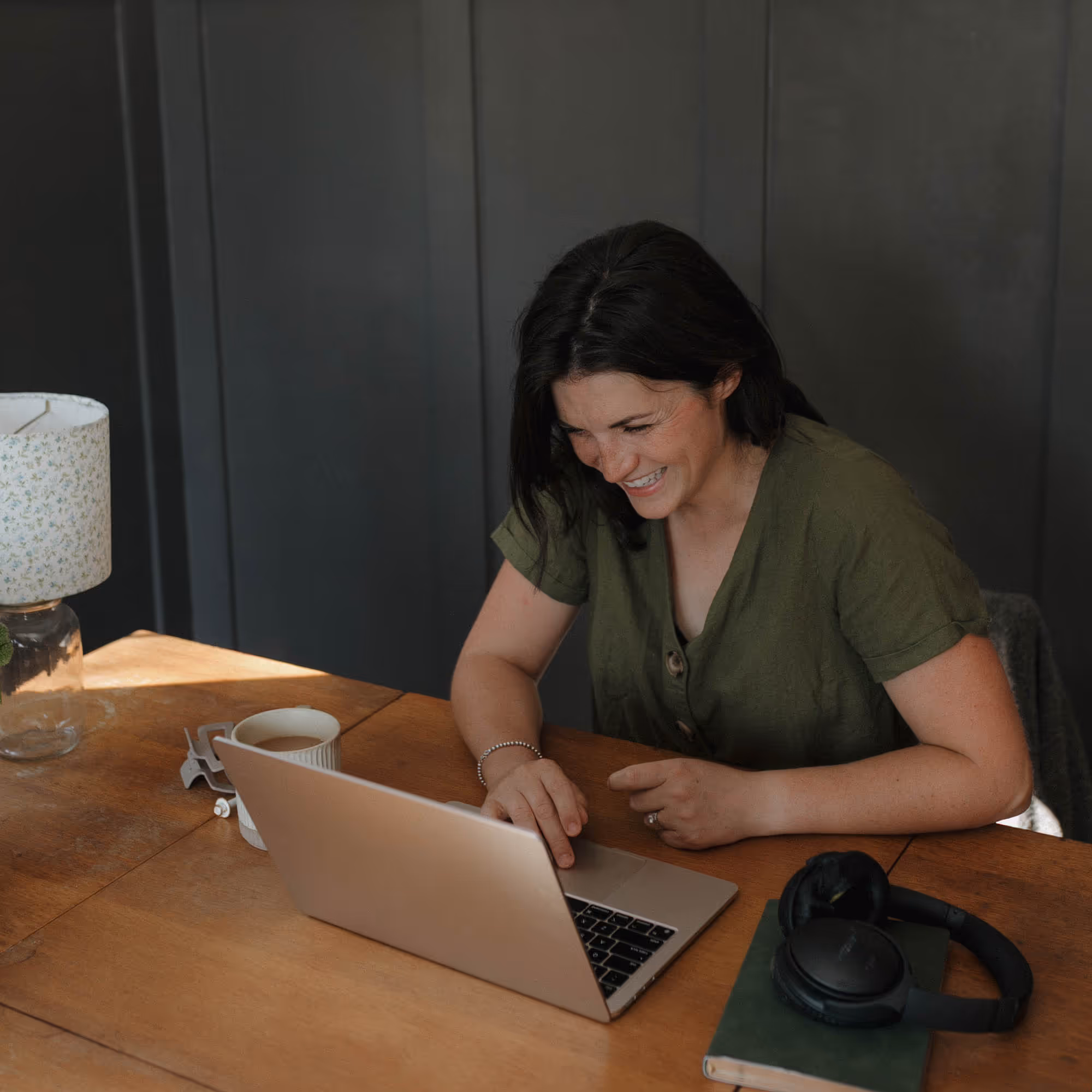 Devyn sat behind her desk laughing in a candid moment.