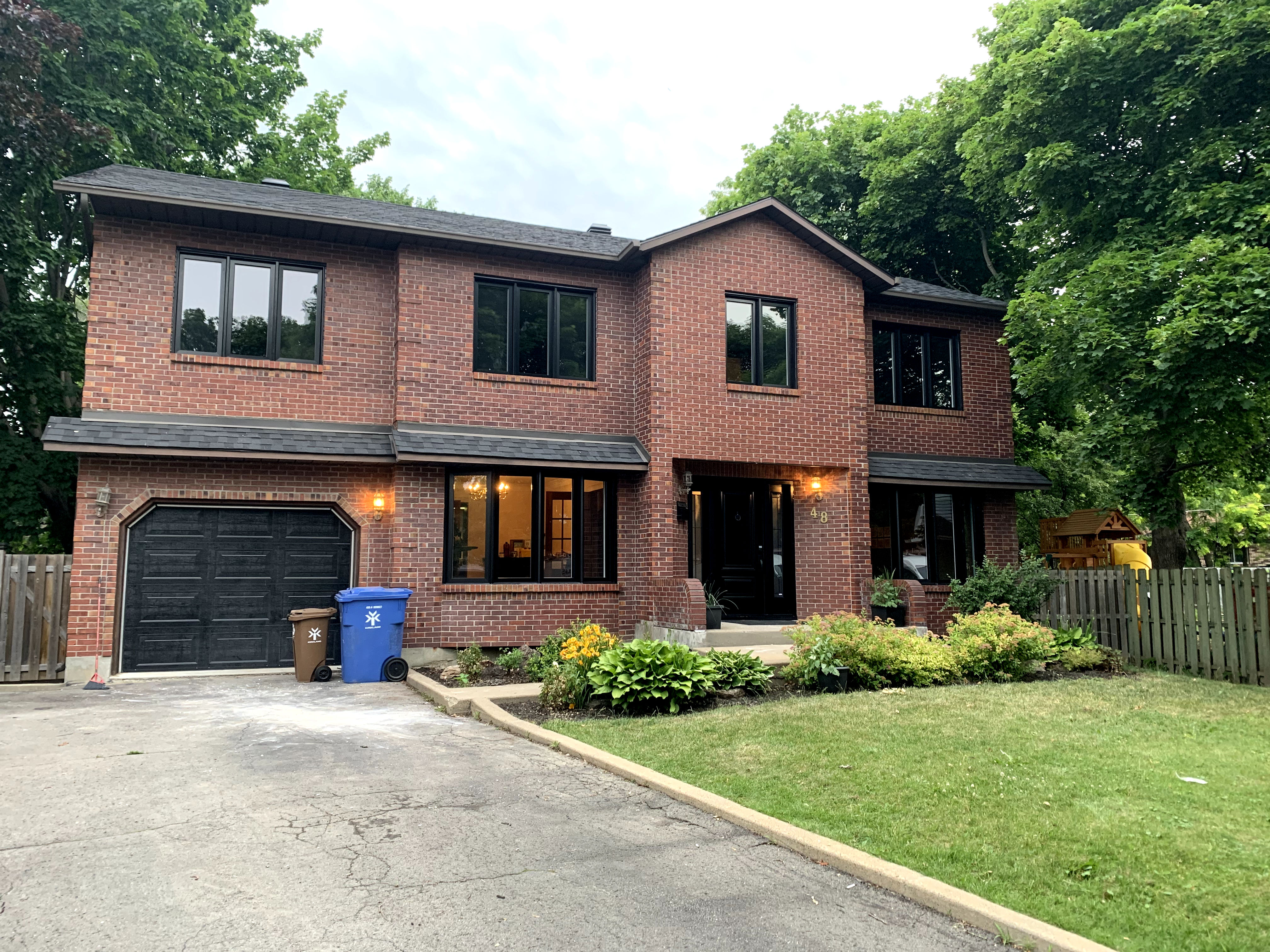 image of a house with black windows, doors and garage door
