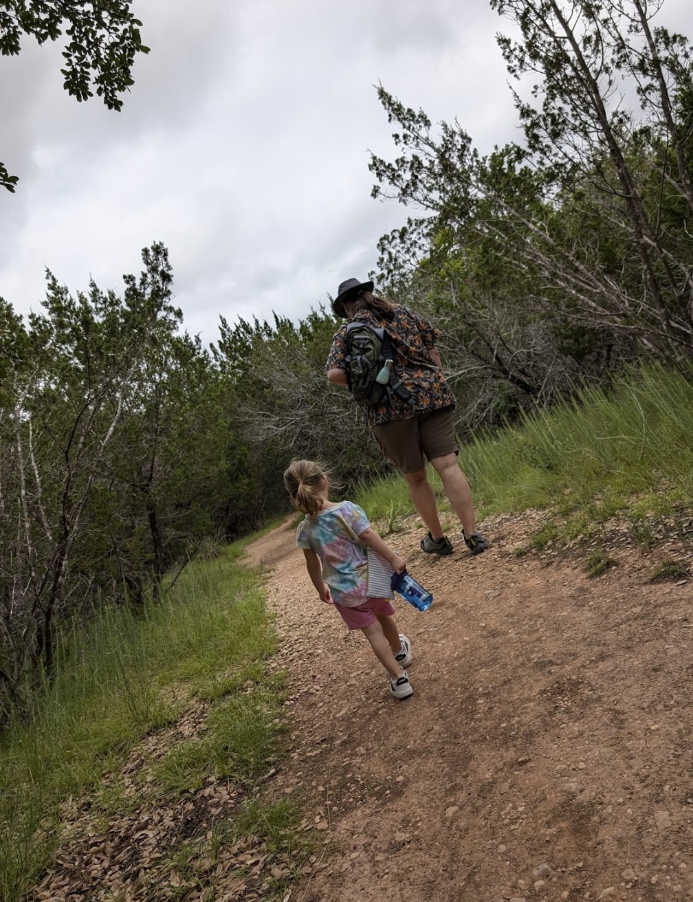 man and little girl hiking