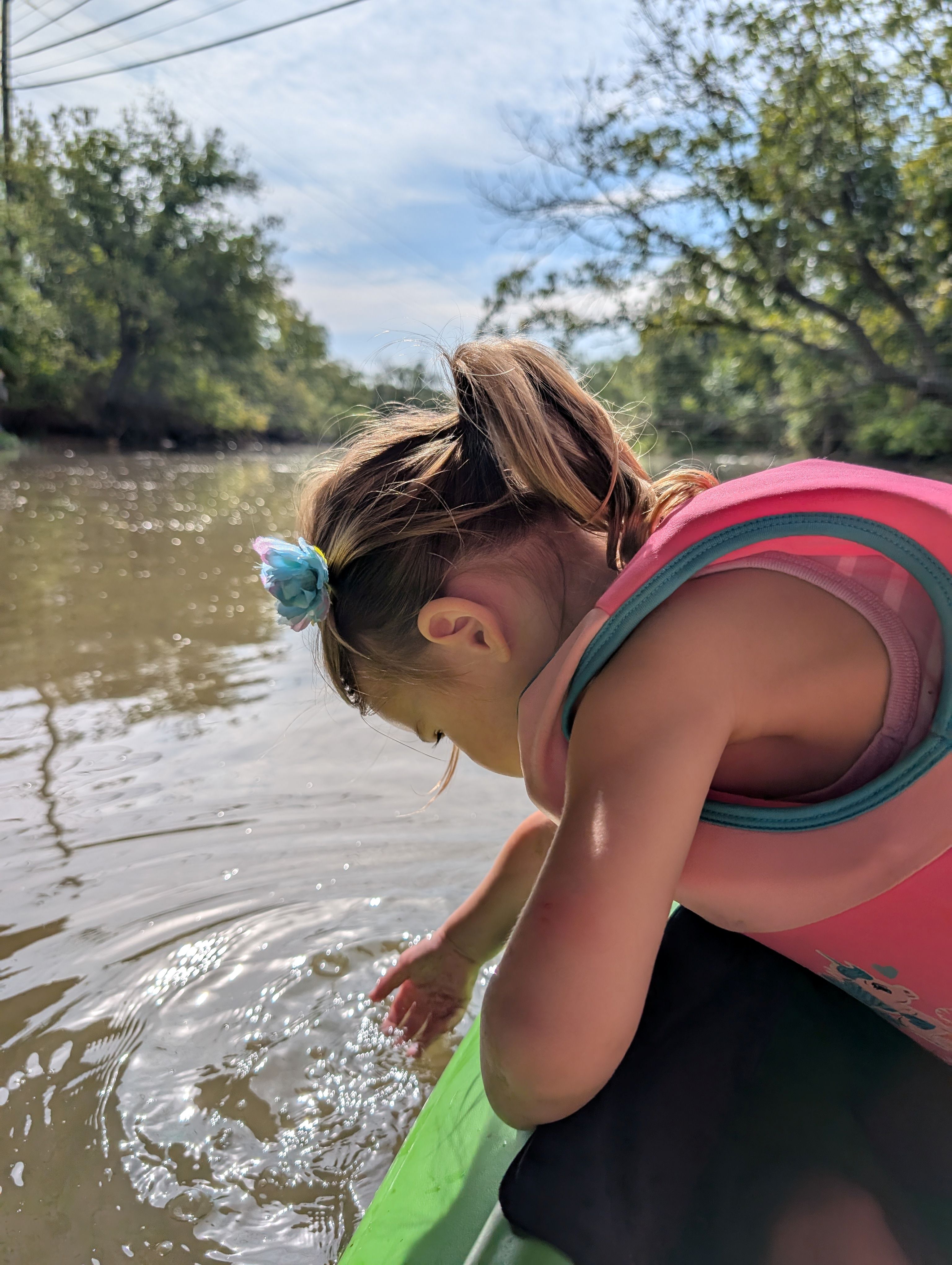 girl leading over side of kayak
