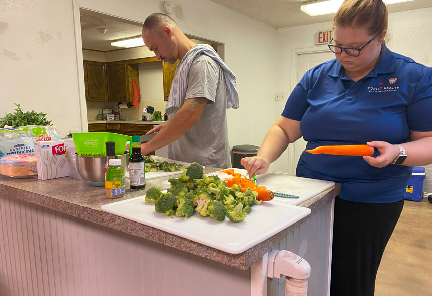 people cutting vegetables