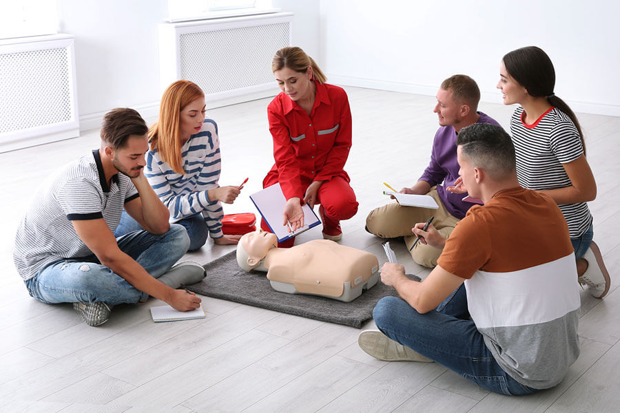 group of people learning CPR