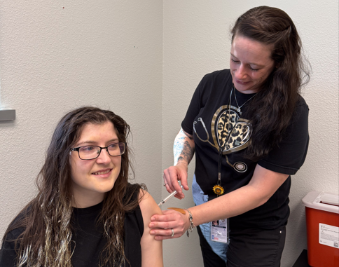 female nurse giving a woman a vaccine