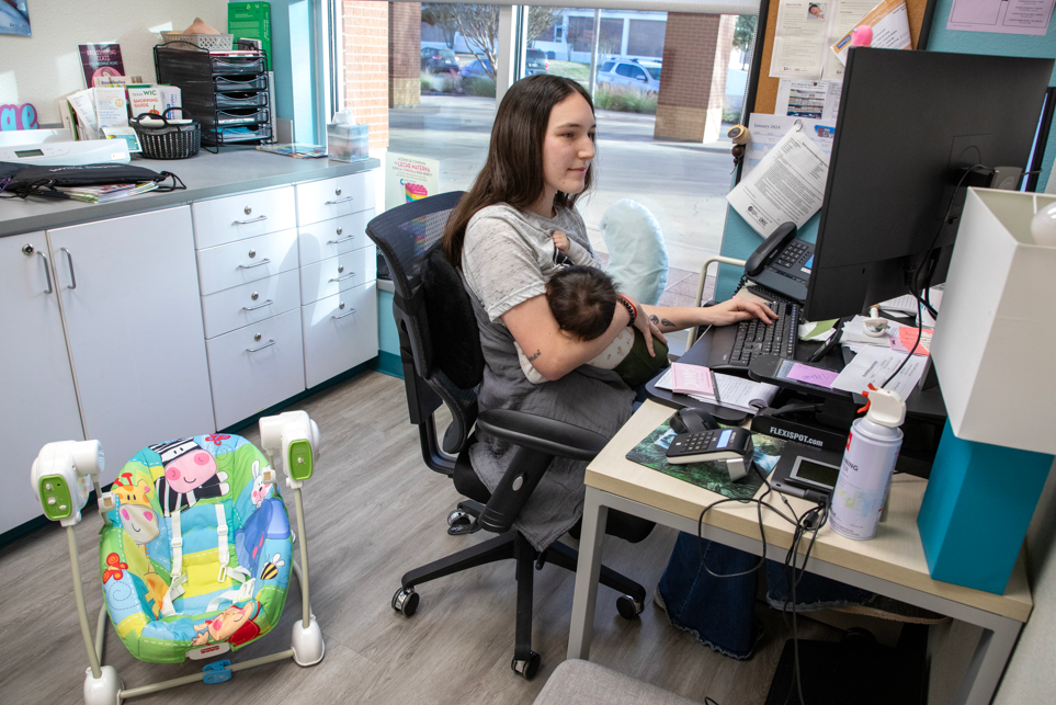 woman breastfeeding while working