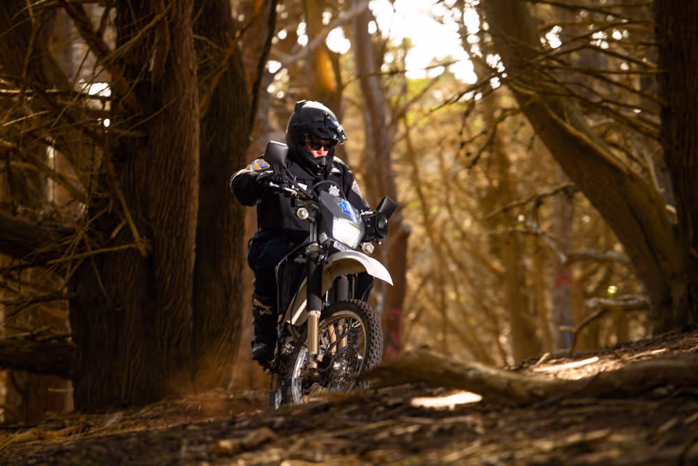 Police officer on the motorcycle on the trail