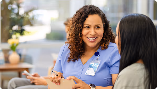 Nurse helping and talking to patient