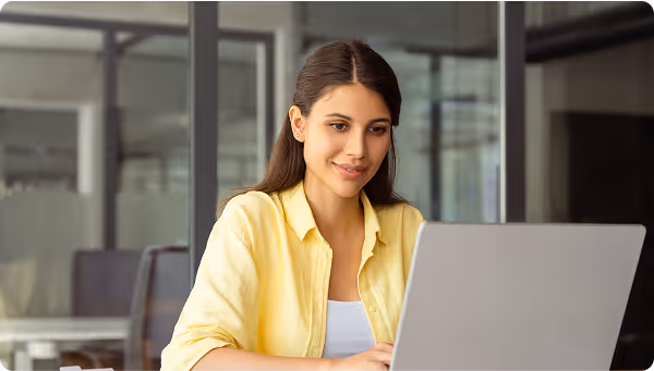 women at laptop smiling