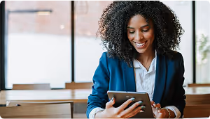 women smiling at tablet