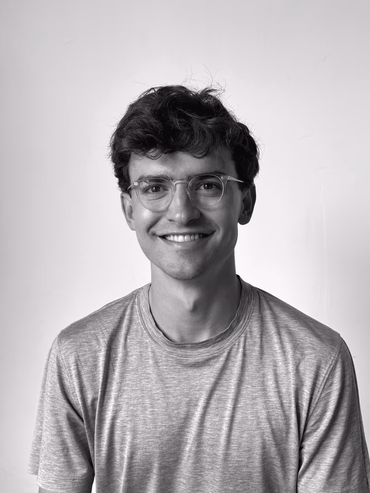 Headshot of Marshall Murphy, a graphic and motion designer, smiling in a minimalist studio setting.