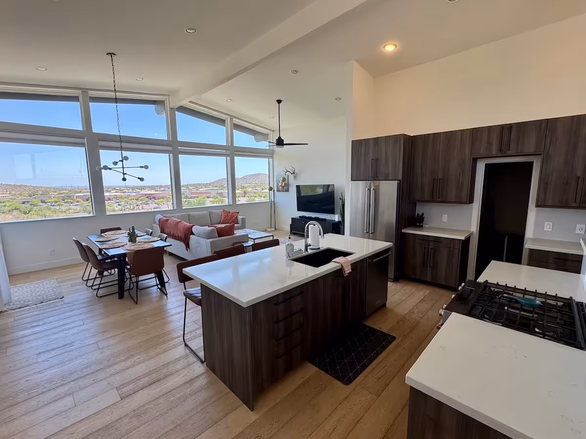 Bright white living room with minimalist furniture professionally cleaned by Spotless Society house cleaning service