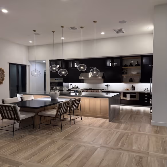 Professional cleaner performing standard house cleaning service in Phoenix home kitchen