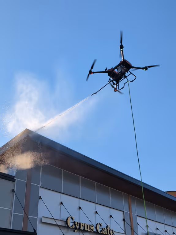 exterior pressure washing building with drone stratosclear
