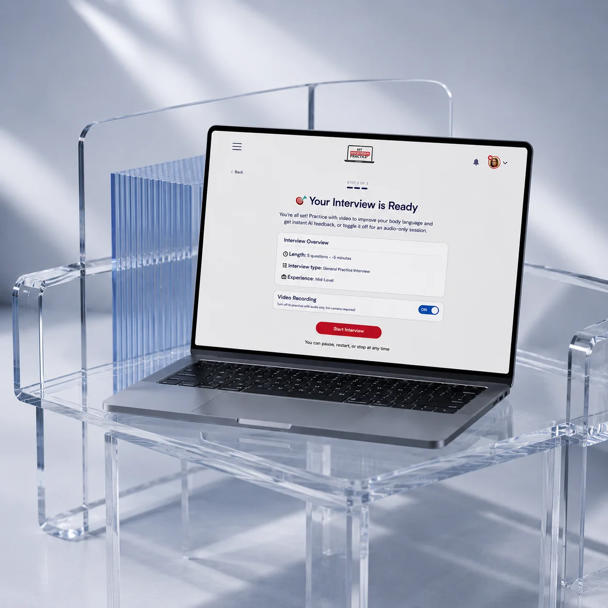 Laptop on clear acrylic chair shows 'Your Interview is Ready' screen for video practice with AI feedback.