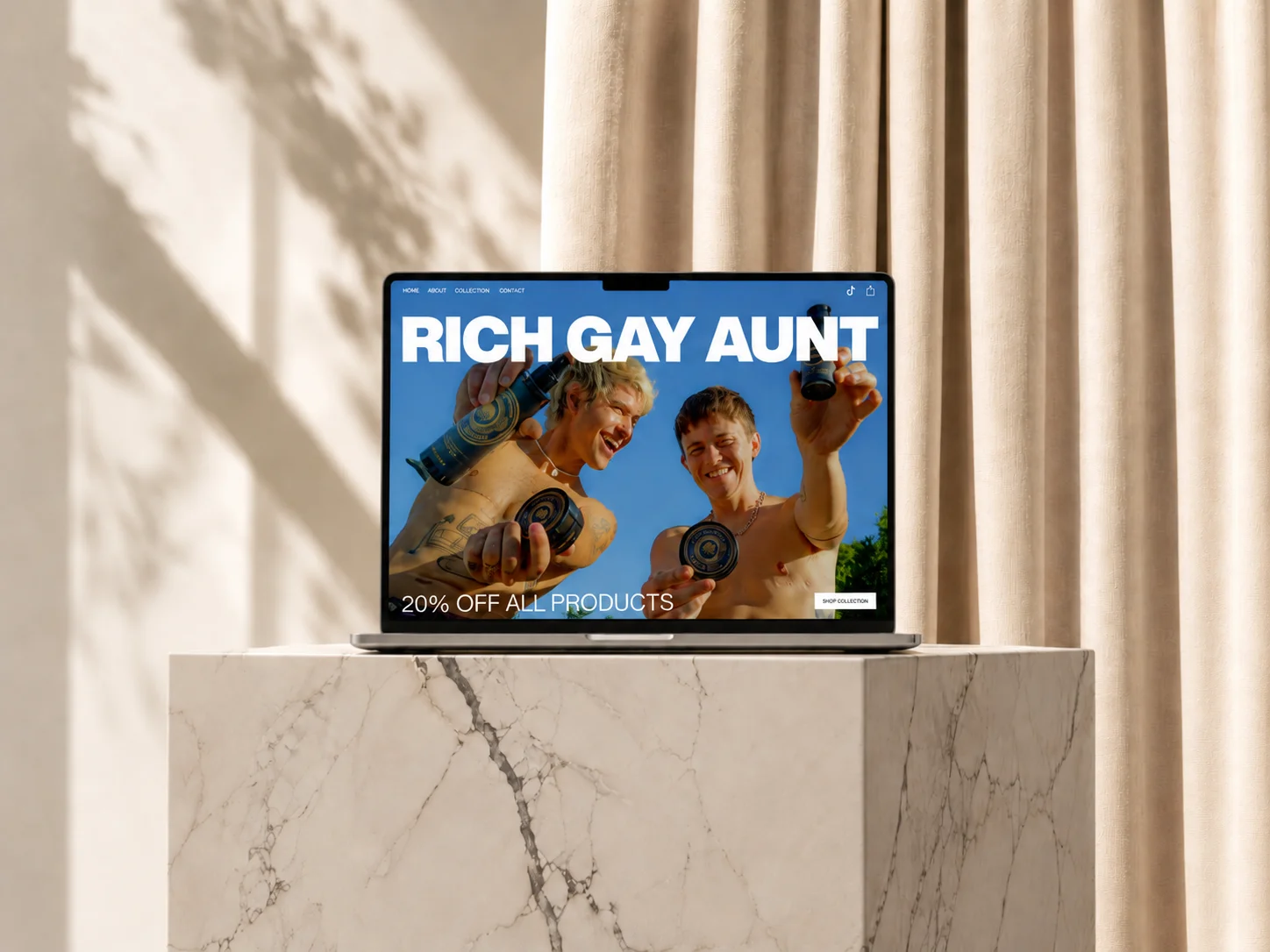 Open laptop on stone steps showing ad with two shirtless men holding skincare products.