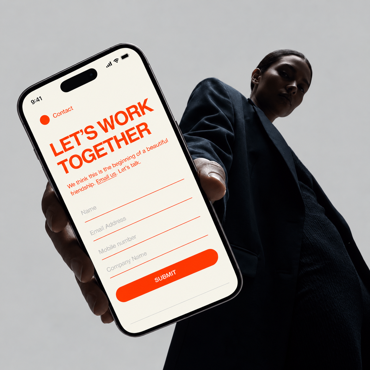 Person holding a smartphone displaying a contact form with bold red text that says LET'S WORK TOGETHER and fields for name, email address, mobile number, company name, and a red submit button.