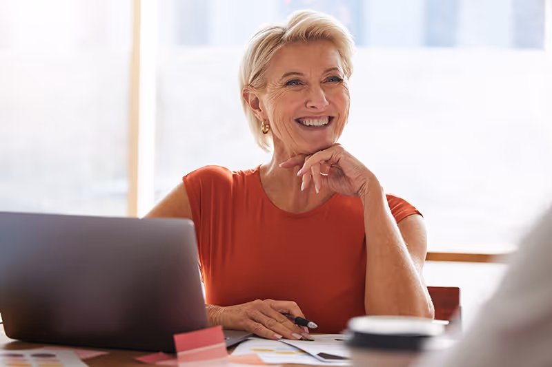 successful business woman smiling at her desk