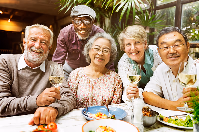 Image of happy elderly friends at a dinner