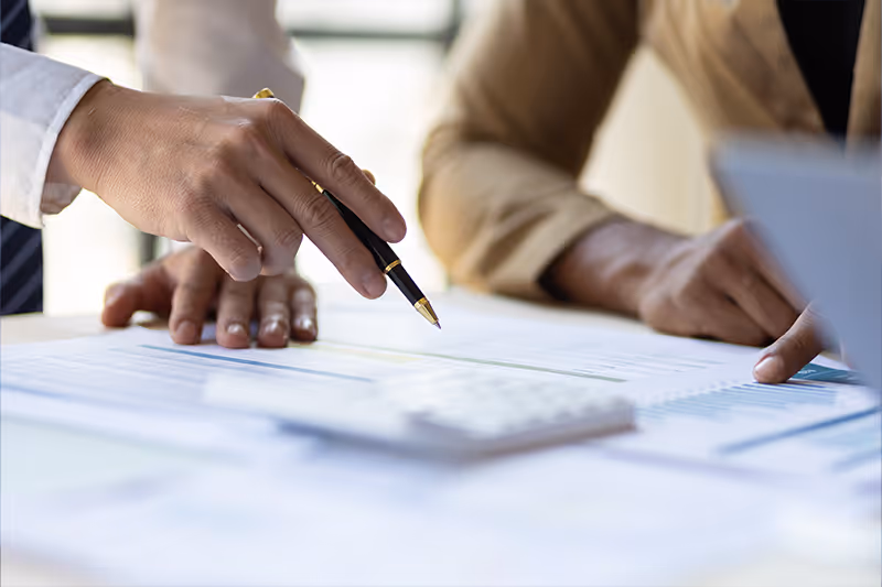 Image of someone helping with paperwork at a desk