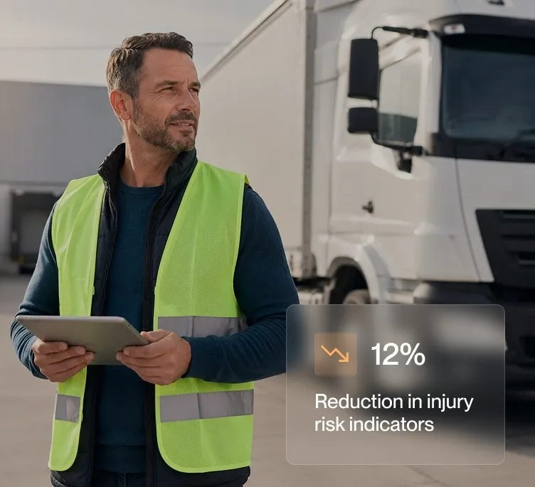 Man in yellow safety vest holding tablet near a white truck with text about 12% injury risk reduction.