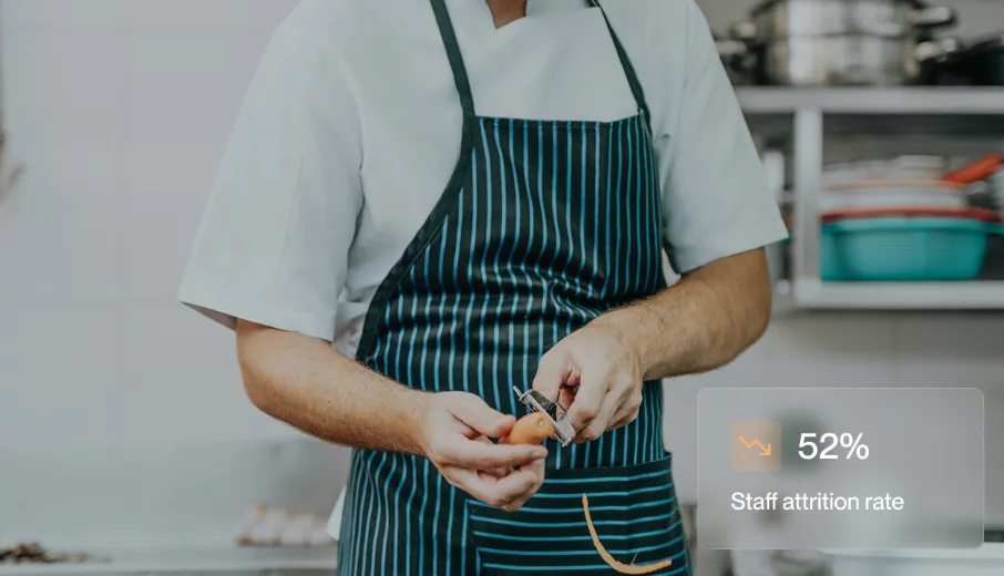 Person in striped apron peeling a carrot in a kitchen with text showing 52% staff attrition rate.