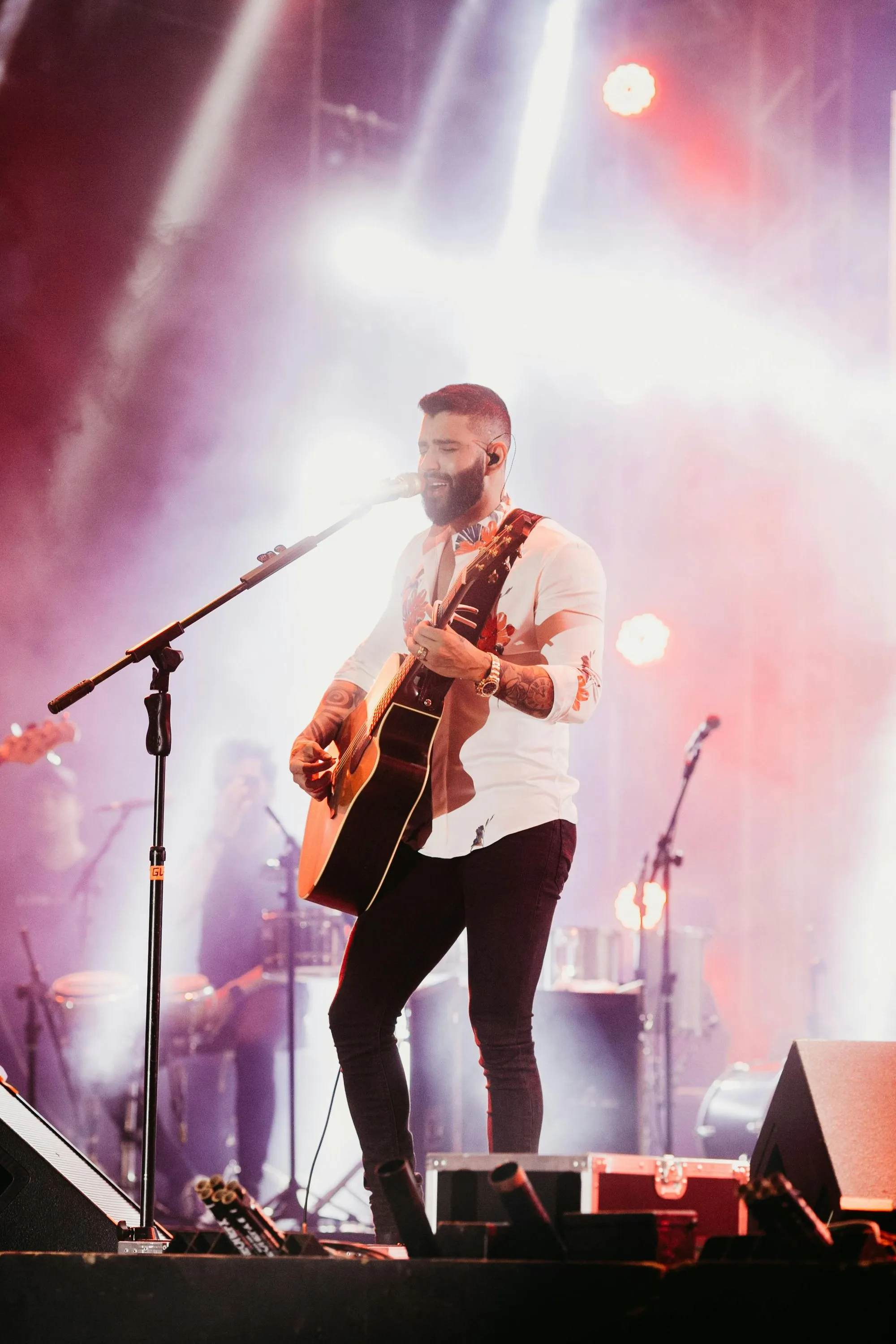 Man performing with guitar on stage