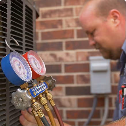 HVAC technician gauges checking refrigerant pressures on a new A2L system HVAC technician gauges checking refrigerant pressures on a new A2L system