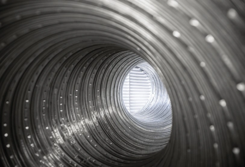 A deep view into a dirty, lint-filled dryer vent duct