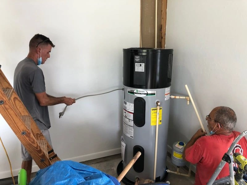 Two men install A.O. Smith water heater.