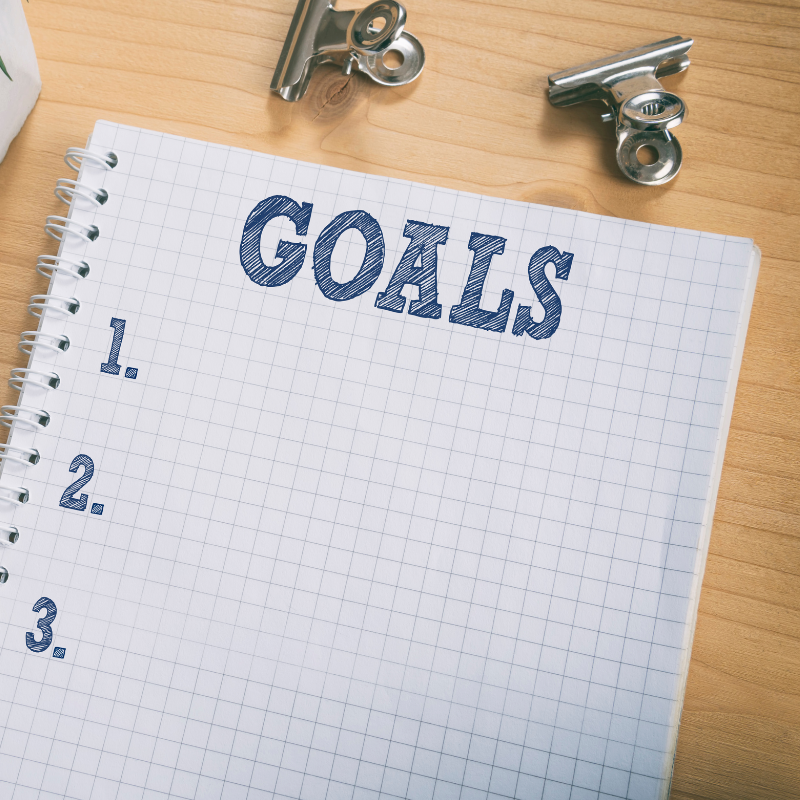 notebook with goals and numbers written