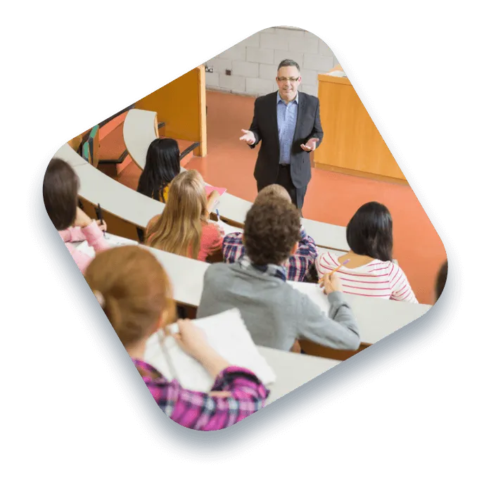 Professor giving a lecture in amphitheater with a few students visible