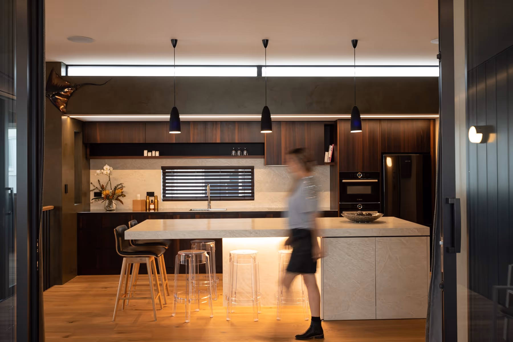 Kitchen the has low lighting, lighting the floor. 