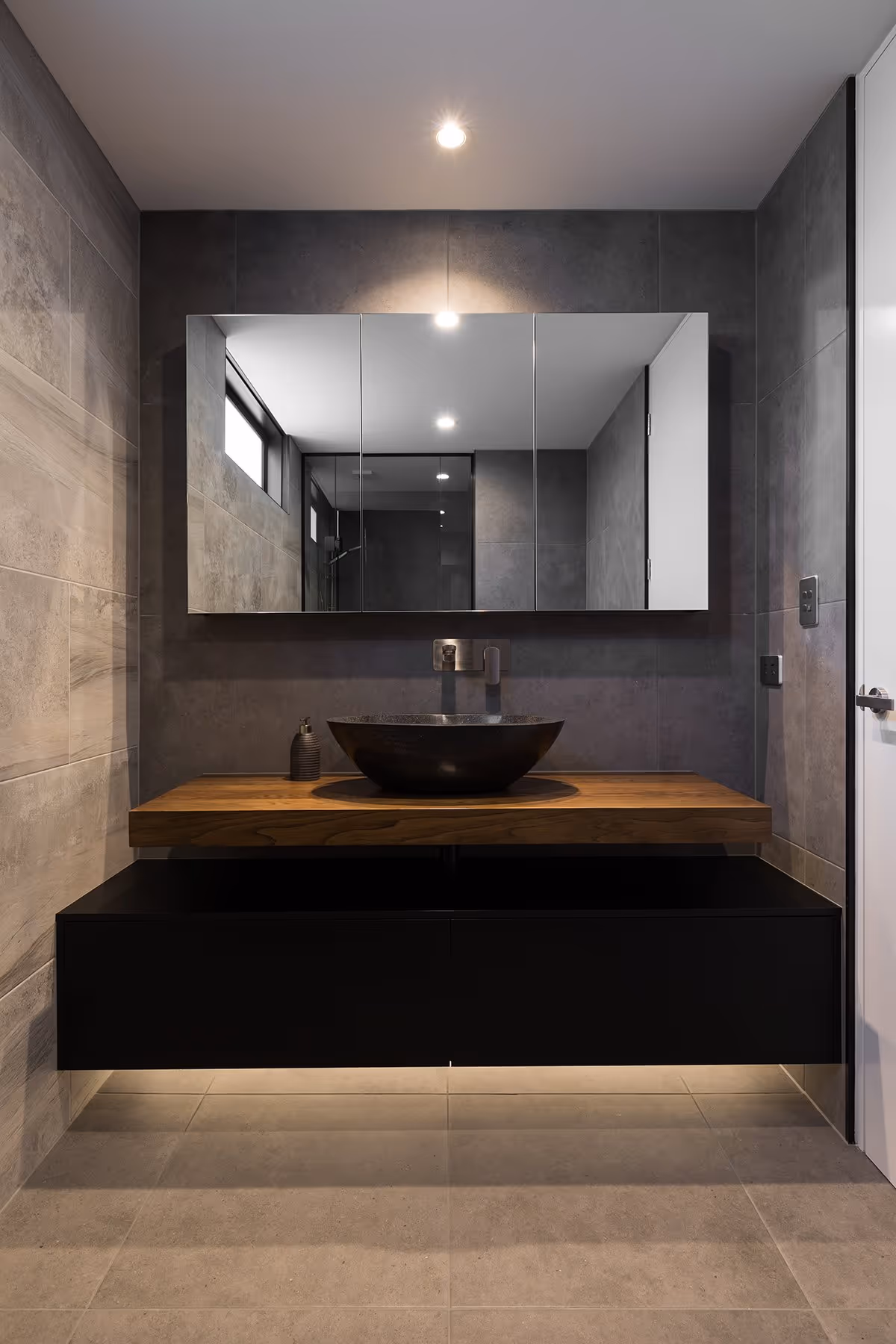 Bathroom with black wall unit. 