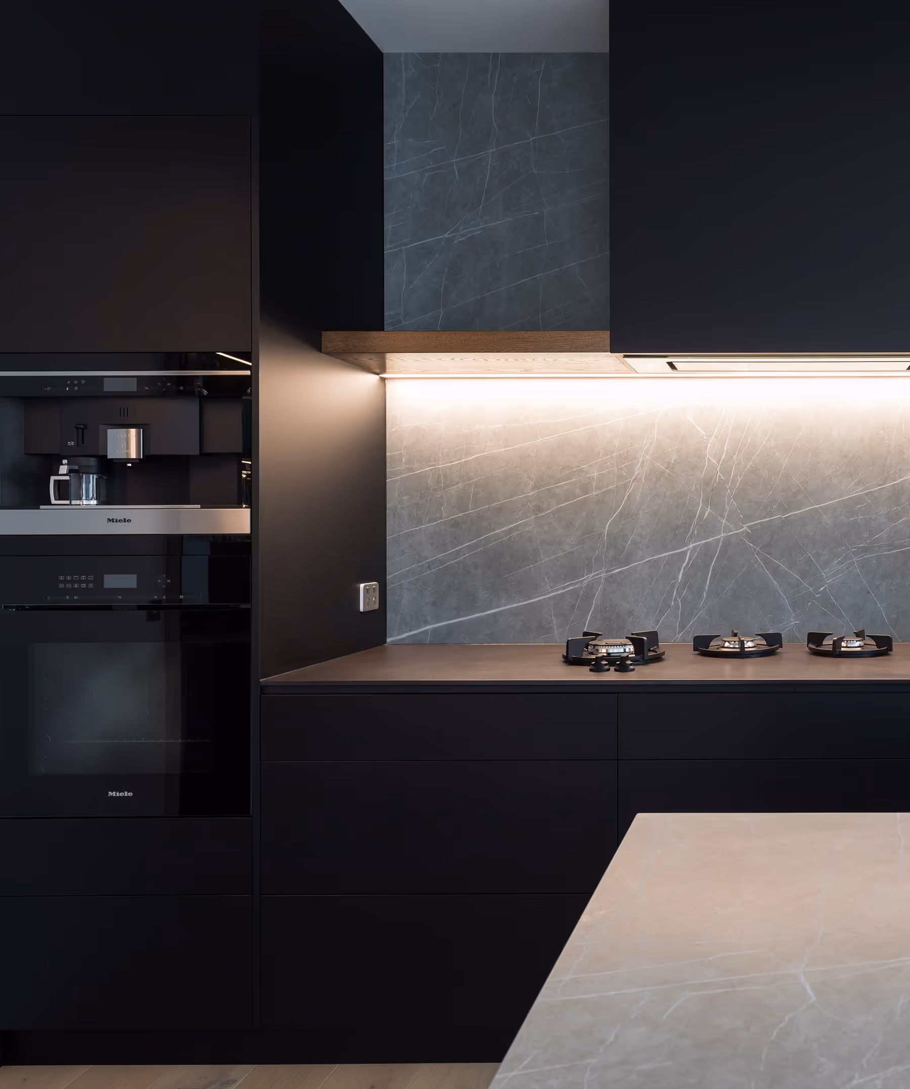 Dark, black kitchen with light gray marble splashback. 