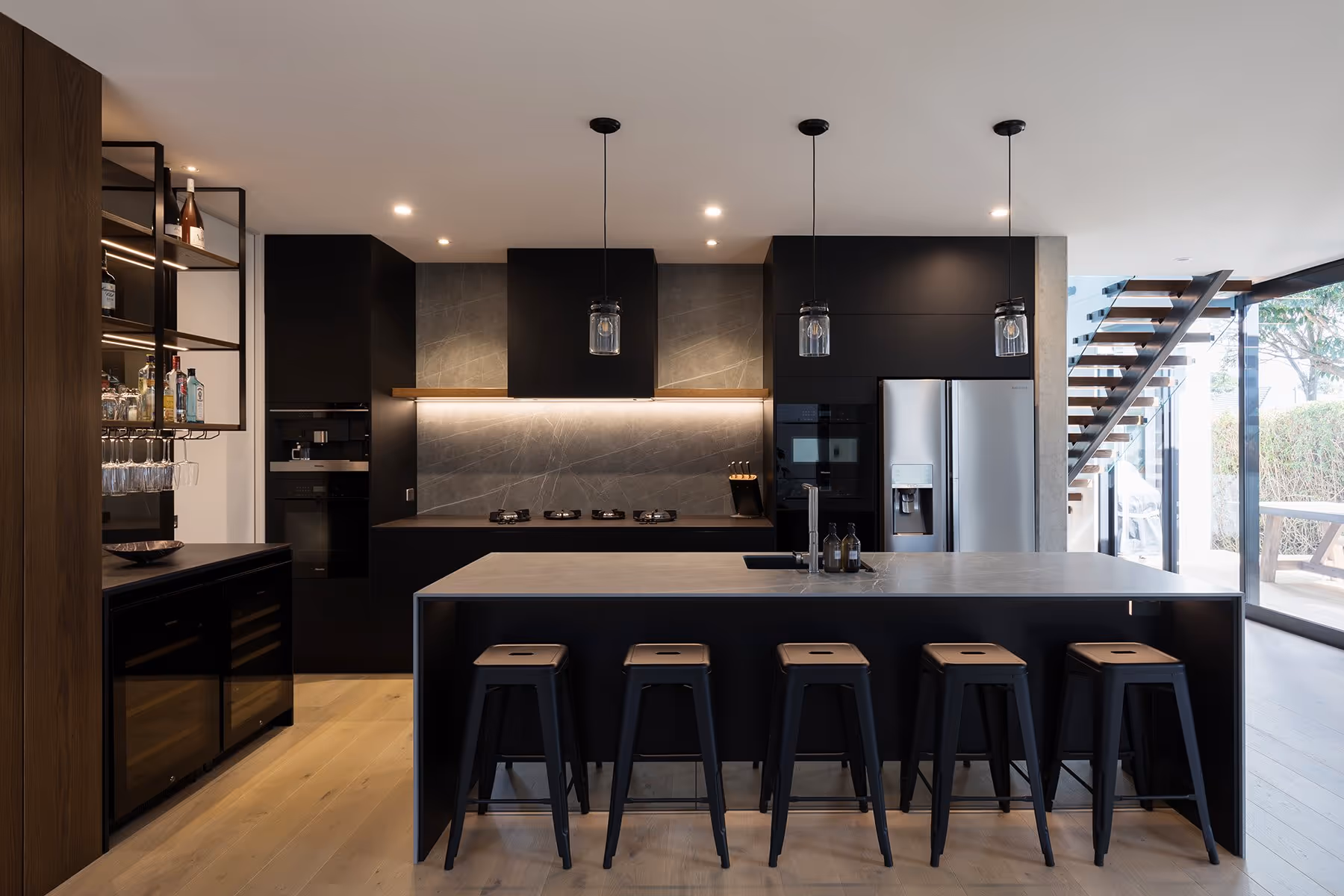 Large, modern kitchen with wooden floor. 