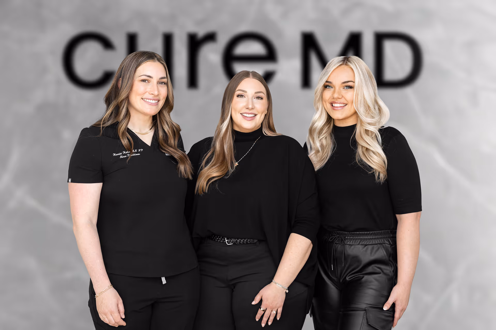 A group of three women standing next to each other.