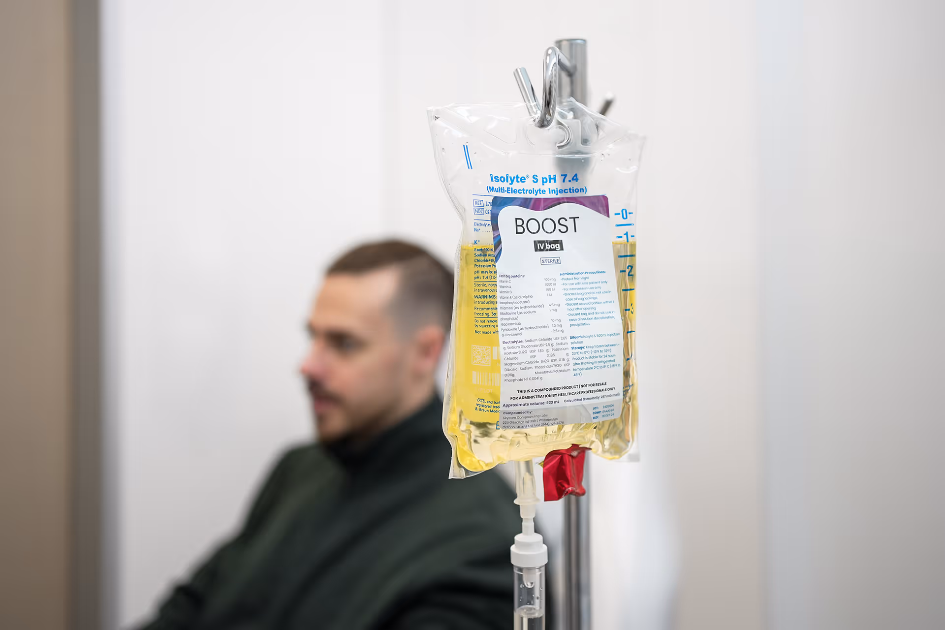 A man in a green jacket is in a clinic.