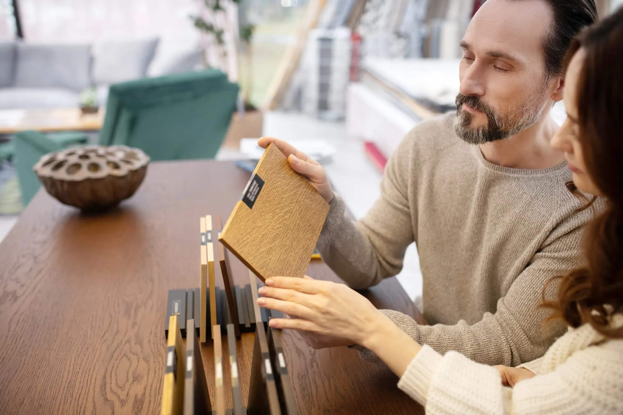 two people discussing furniture swatches