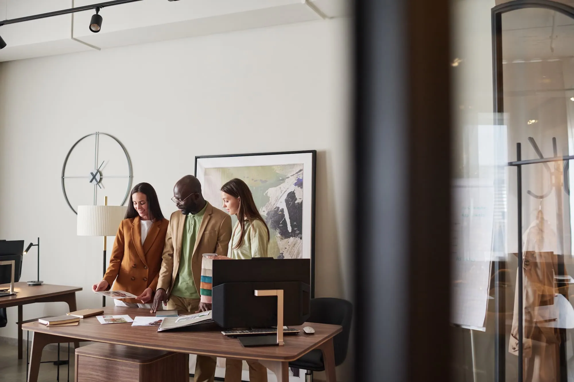 group of interior designers and sales advisors looking through catalogue 